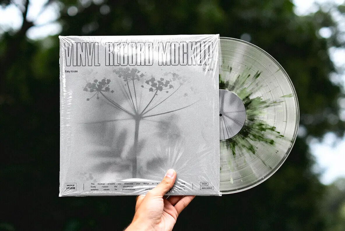Hand Holding Vinyl Record Mockup Graphics - YouWorkForThem