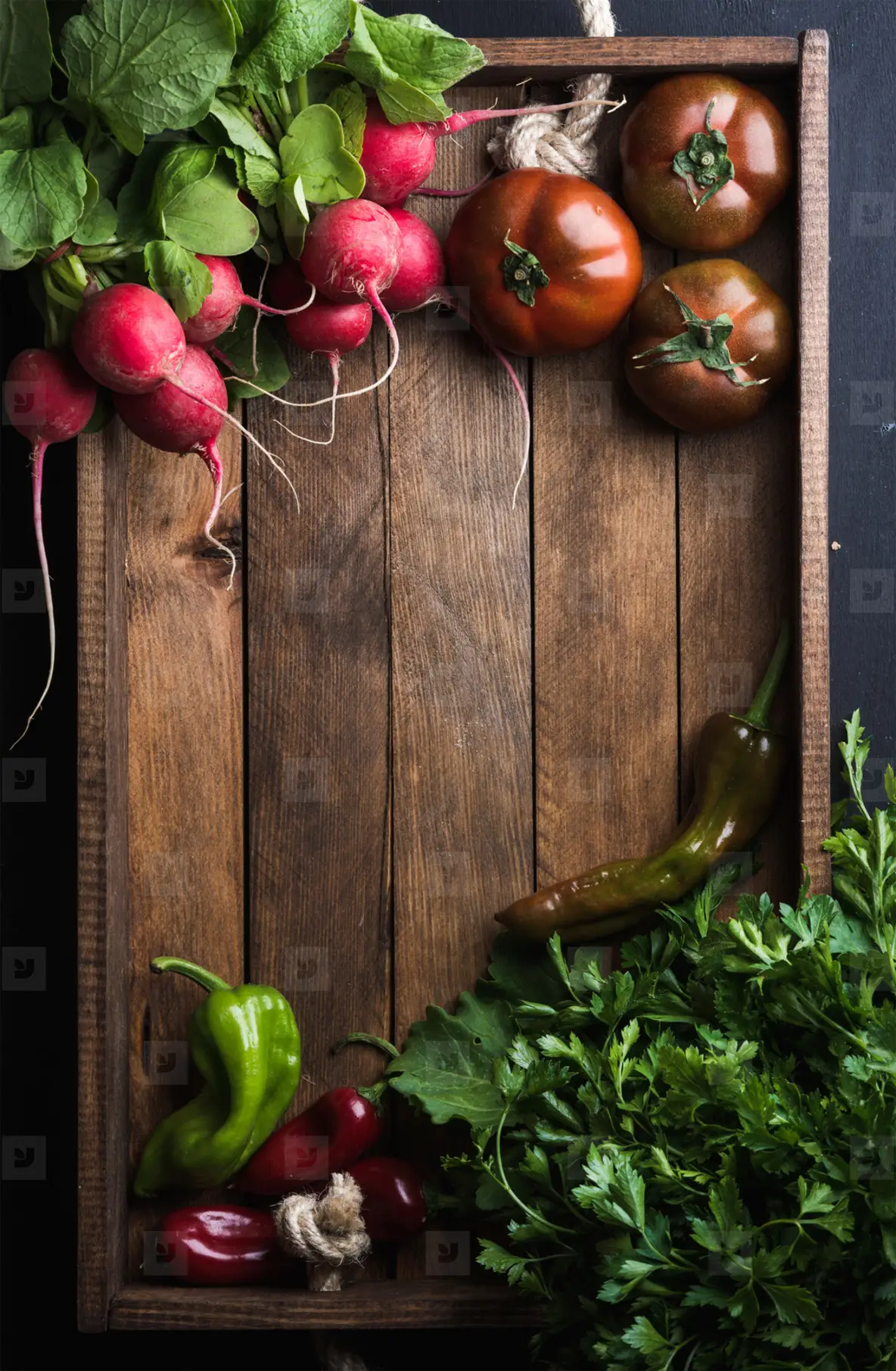 Fresh raw ingredients for healthy cooking or salad making  in rustic wooden tray over black background  top view  copy space  Diet  vegetarian food concept