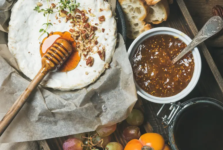 Camembert, grapes, persimmon, fig jam, honey, baguette, glass of rose