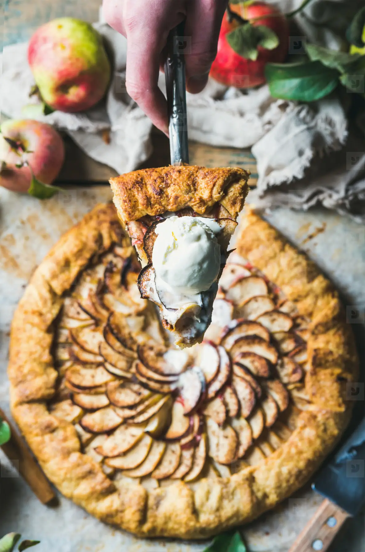 Man s hand holding slice of homemade apple crostata pie