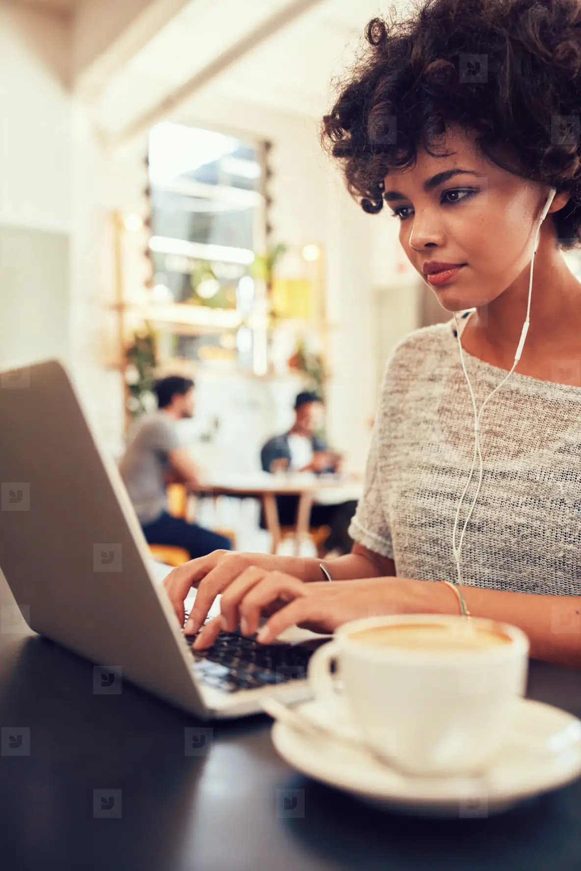 African Woman At A Coffee Shop Using Laptop Photo (121679) - YouWorkForThem