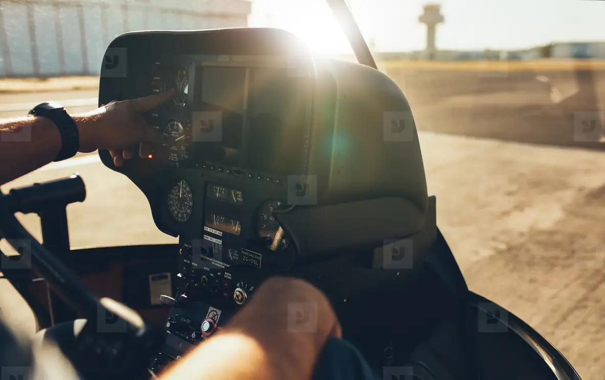Helicopter pilot checking gauges on the instrument panel