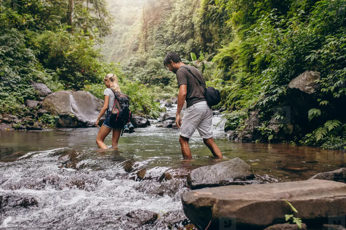 Couple Walking Across The Stream Photo (122953) - YouWorkForThem