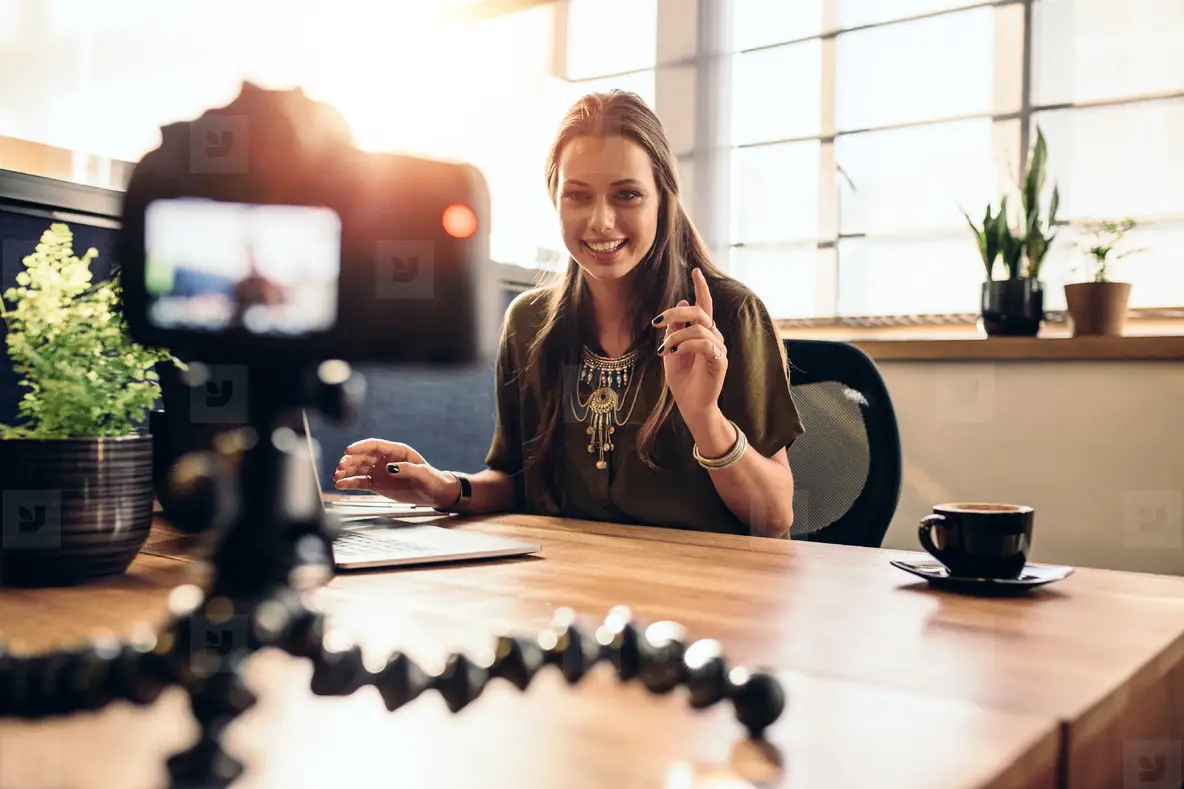 Young female vlogger recording content for her video blog