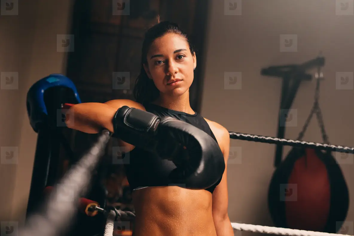 Female Athlete Stands Against Ropes In Boxing Ring Photo (126613 ...