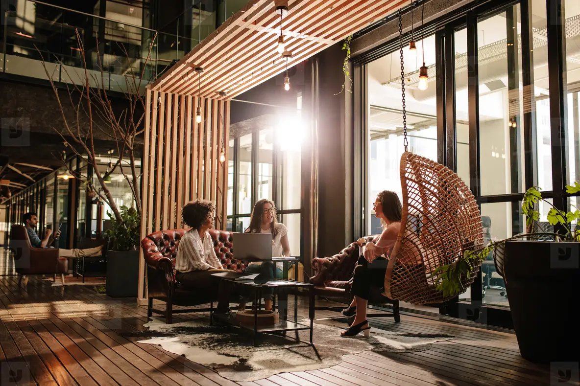 Young women discussing new business ideas in creative office