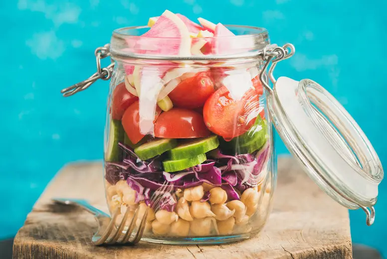 Vegetable and chickpea sprout vegan salad in jar, square crop
