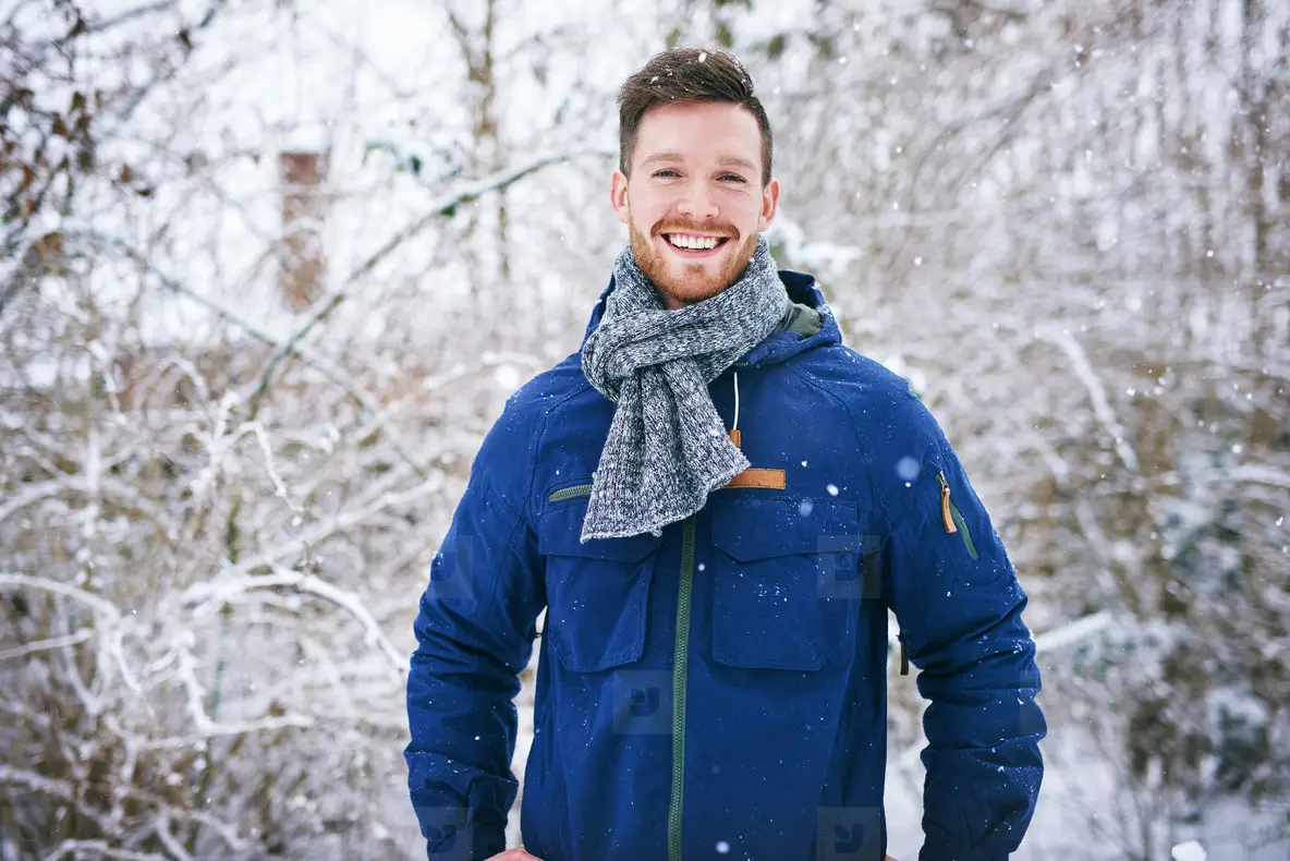 Handsome male in coat smiling at camera