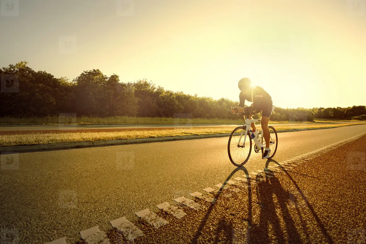 Fit Person Riding A Bike In Sunset Photo (136051) YouWorkForThem