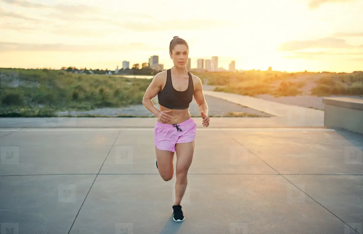 Muscular active woman working out running