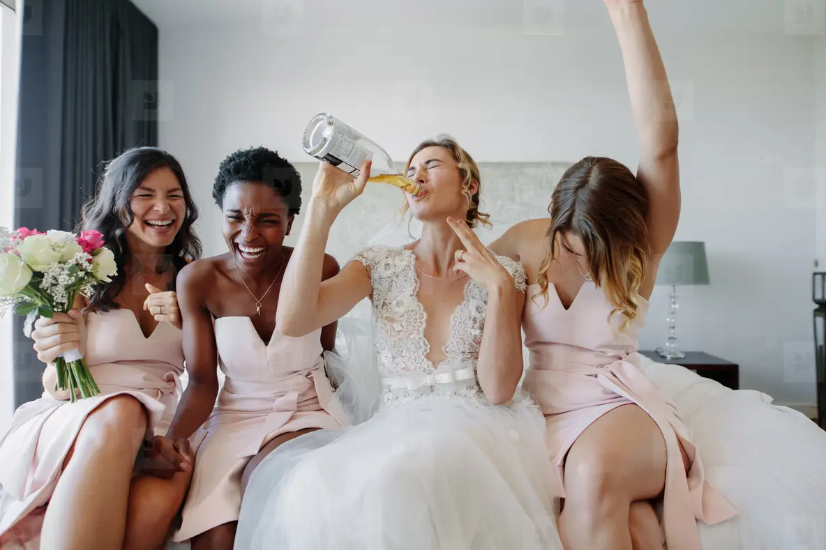 Bride And Bridesmaids Enjoying Before Wedding In Hotel Room Photo