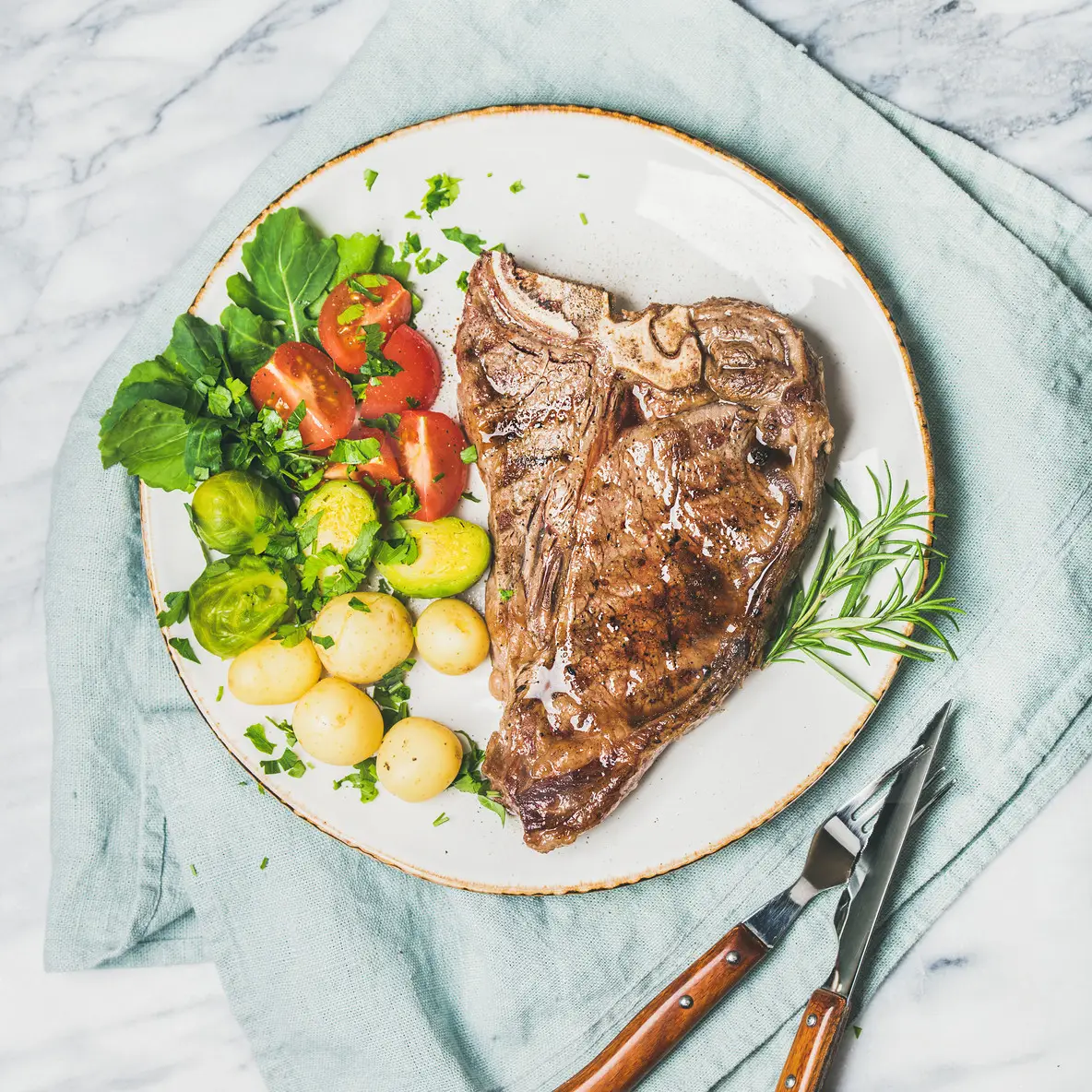 Meat dinner plate with cooked beef tbone steak  square crop