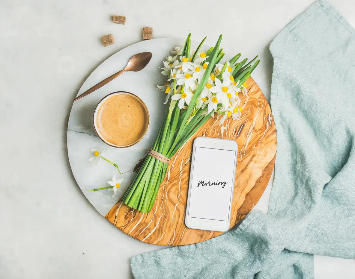 Coffee  bucket of flowers and mobile phone with Morning word
