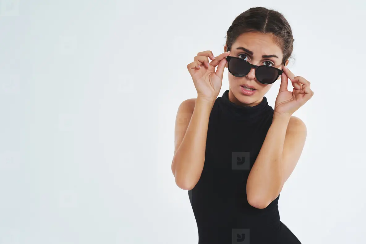 Sexy Young Woman Looking Over Her Sunglasses Photo (140634