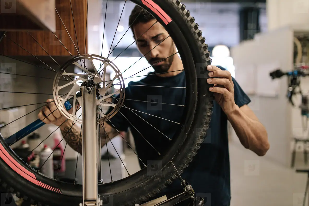 Mechanic repairing a bicycle in workshop