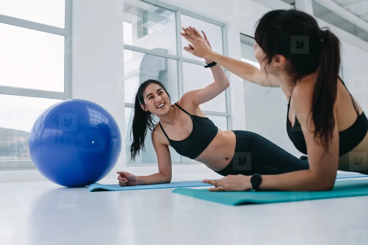 Girls giving high five while working out