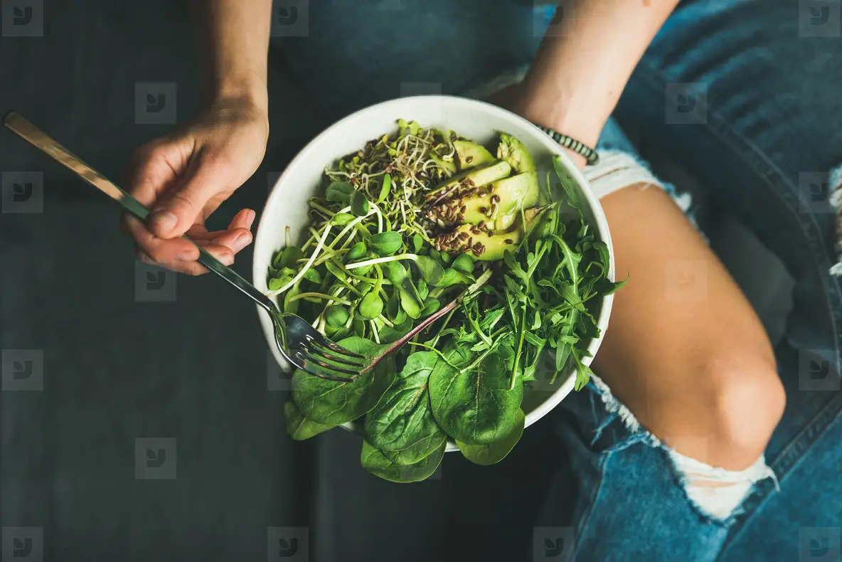 Clean eating breakfast with spinach  arugula  avocado  seeds and sprouts