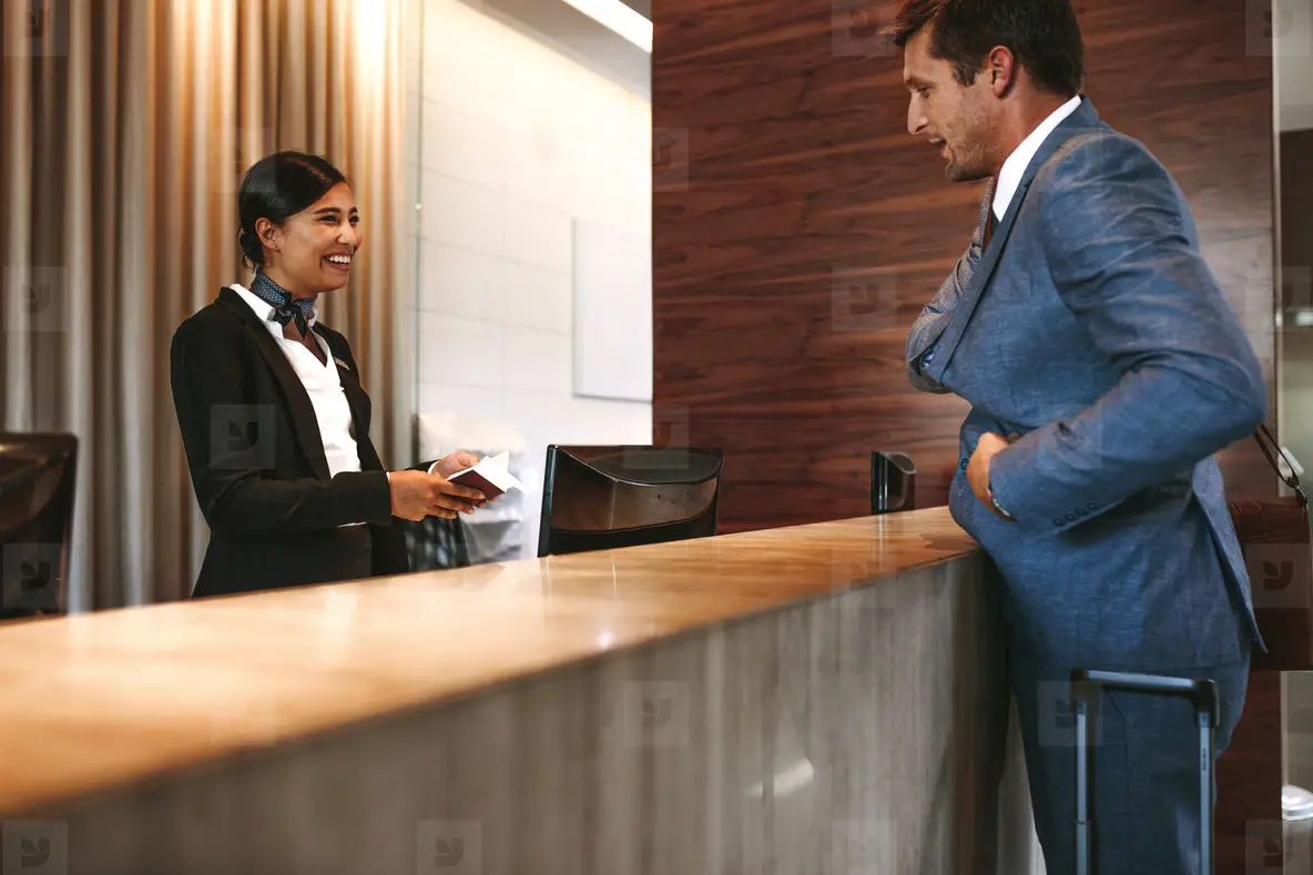 Reception Incheckning Businessman Checking In At Hotel Reception Photo (151334) - YouWorkForThem