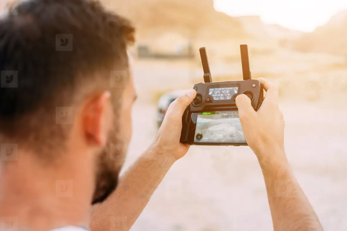 Guy controls drone with remote control