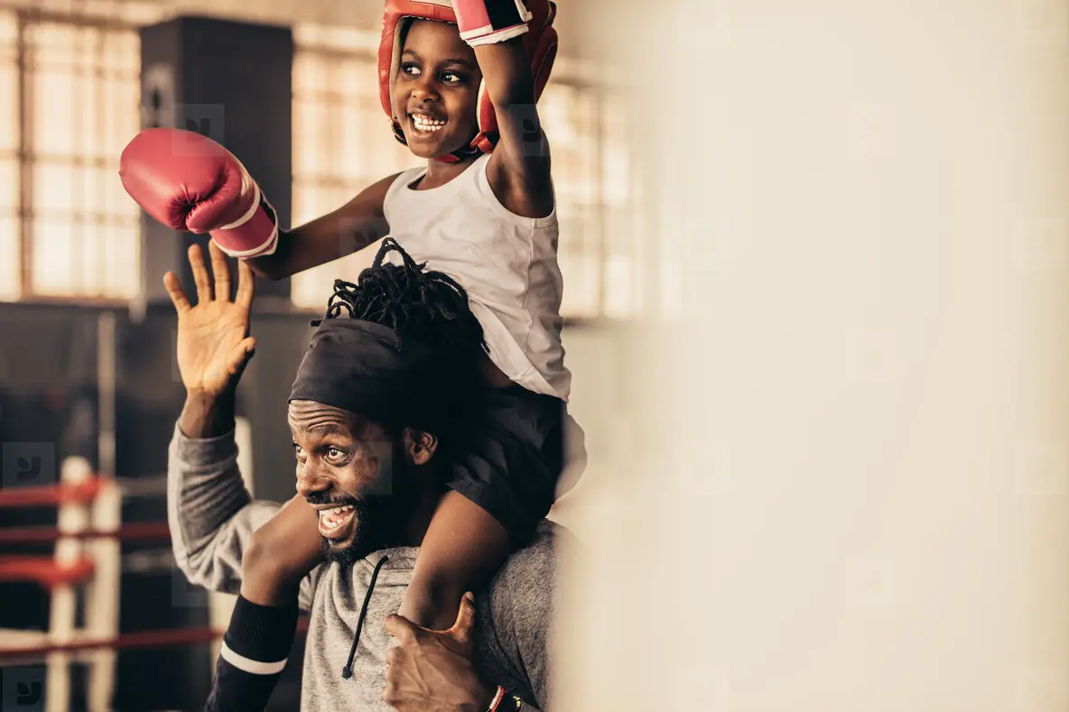 Smiling Boxer Kid Sitting On The Shoulder Of His Trainer Photo (153762 ...