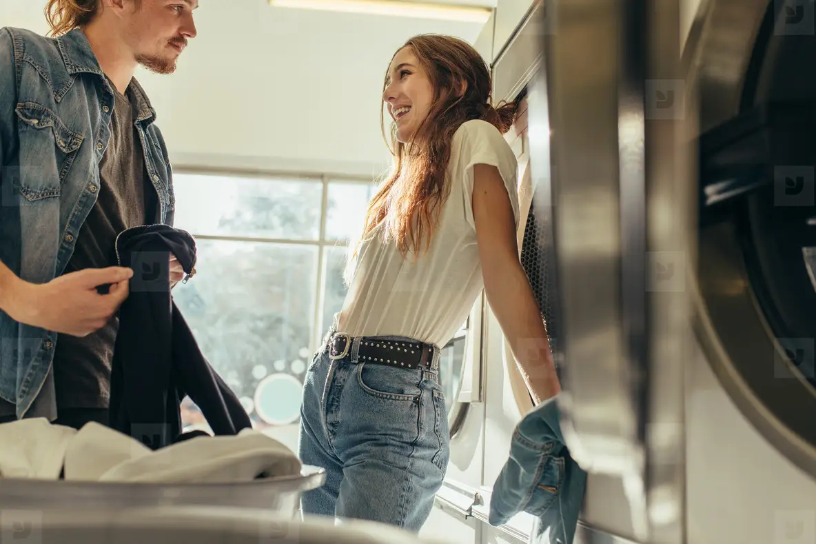 Couple Standing In A Laundry Room Looking At Each Other Photo (154354 ...