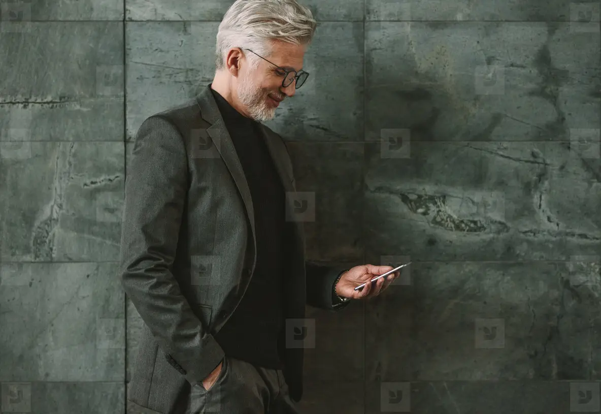 Senior businessman using mobile phone