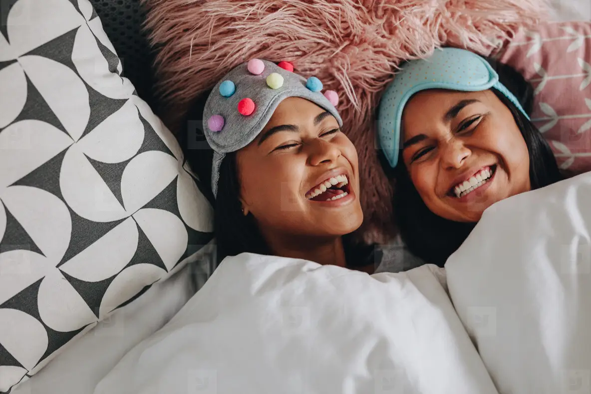 Happy Girl Friends Laughing Lying On Bed Photo (164246) - YouWorkForThem