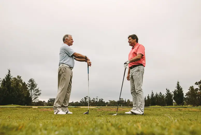 Senior golfers talking at golf course