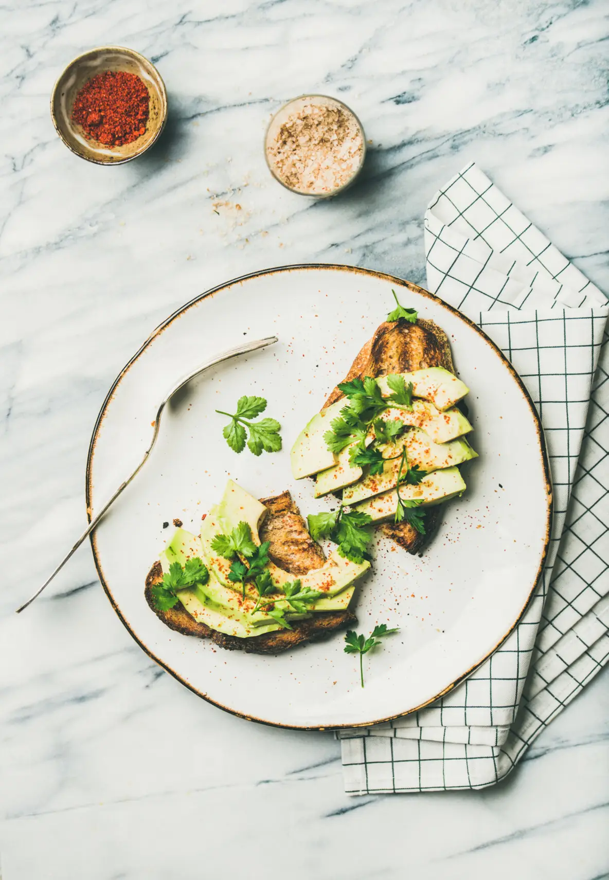 Flat lay of avocado toast with seasoning