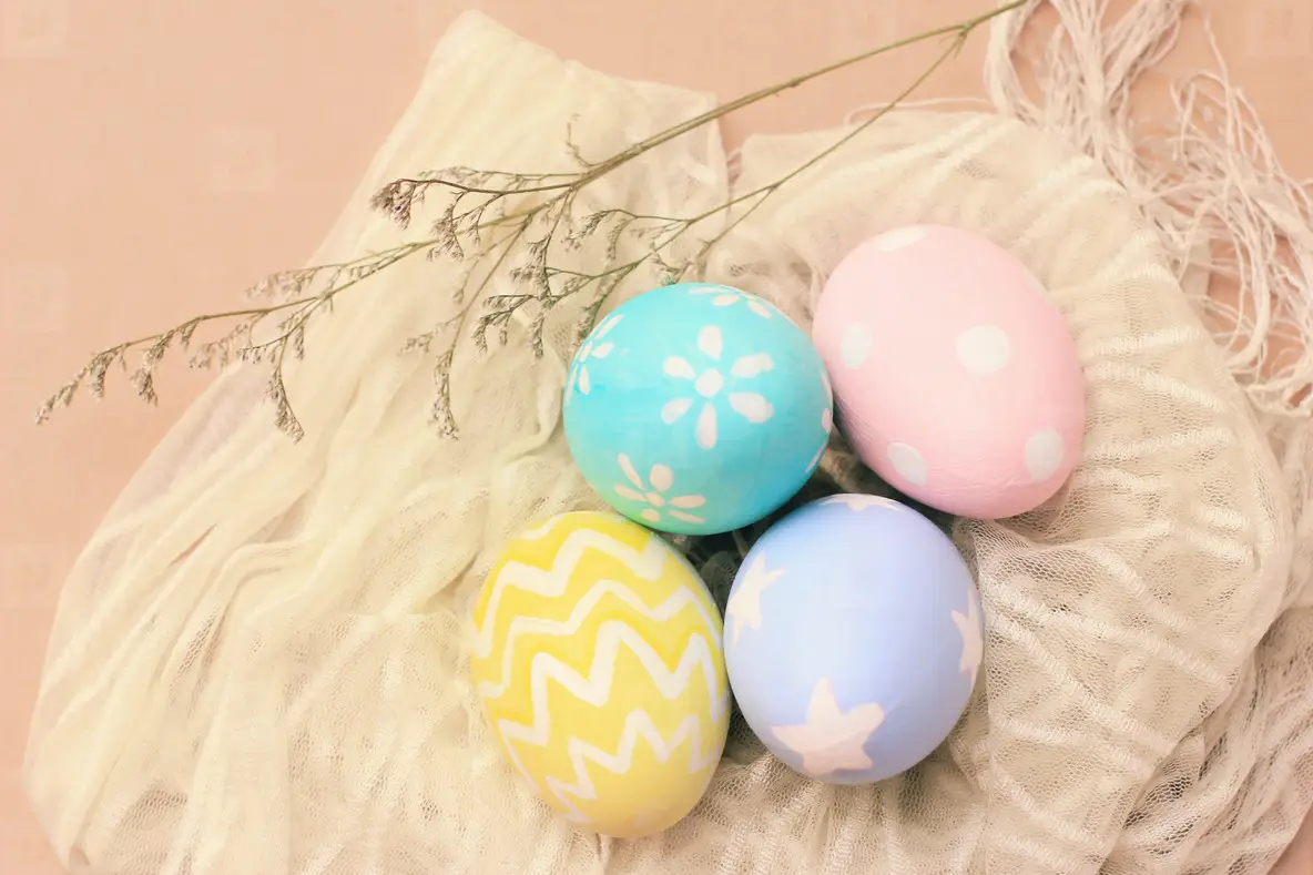 Pastel and colorful easter eggs on cloth with copy space  happy