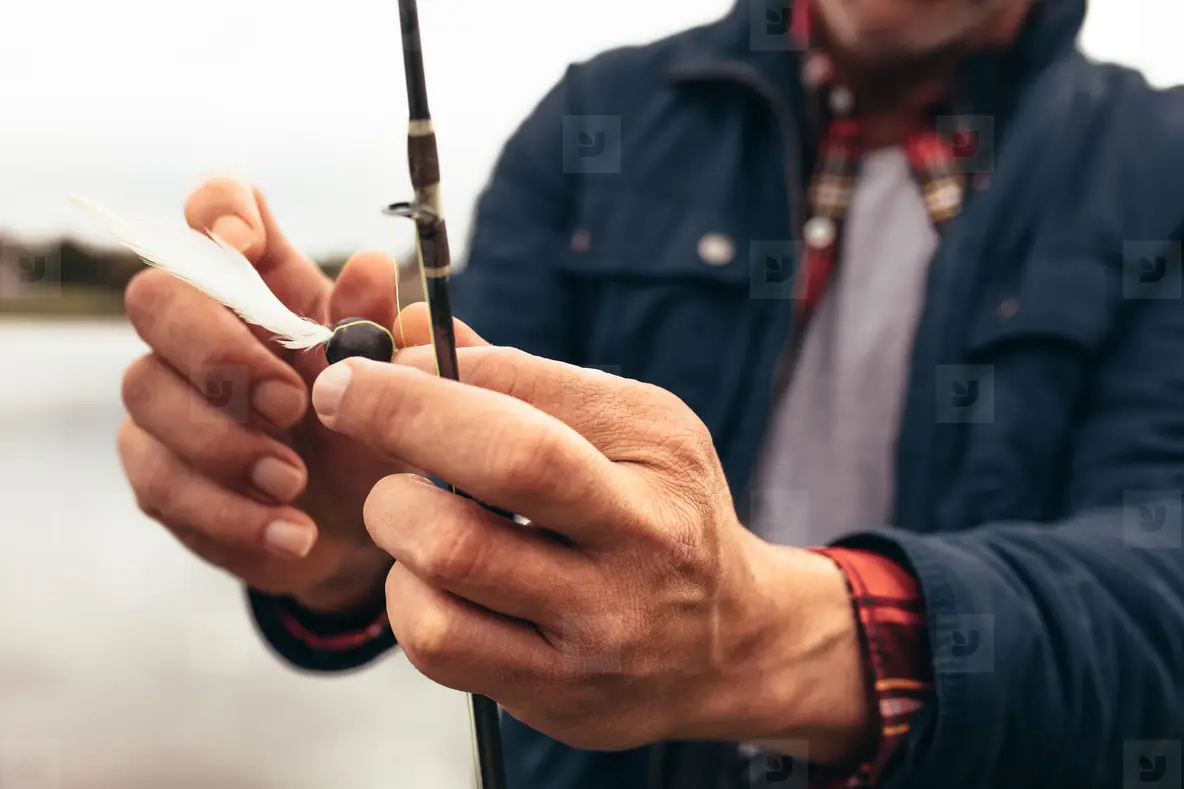 Man Fixing Bait To His Fishing Rod To Catch Fish Photo (169323 ...