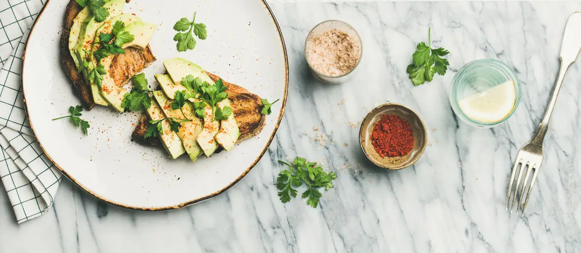 Avocado toast with seasoning and lemon water