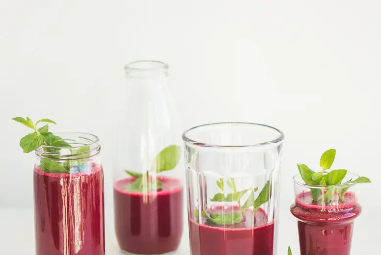 Fresh beetroot smoothie or juice in glasses with mint