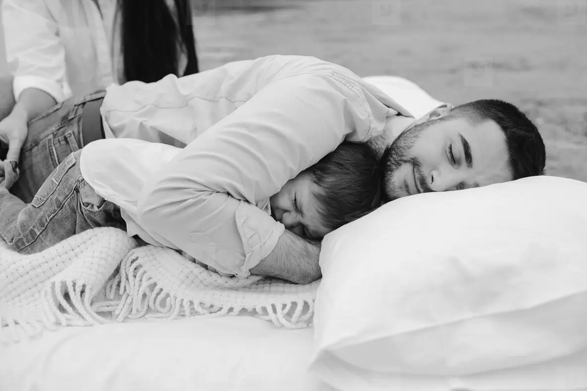 Happy young family relaxing together on the lake