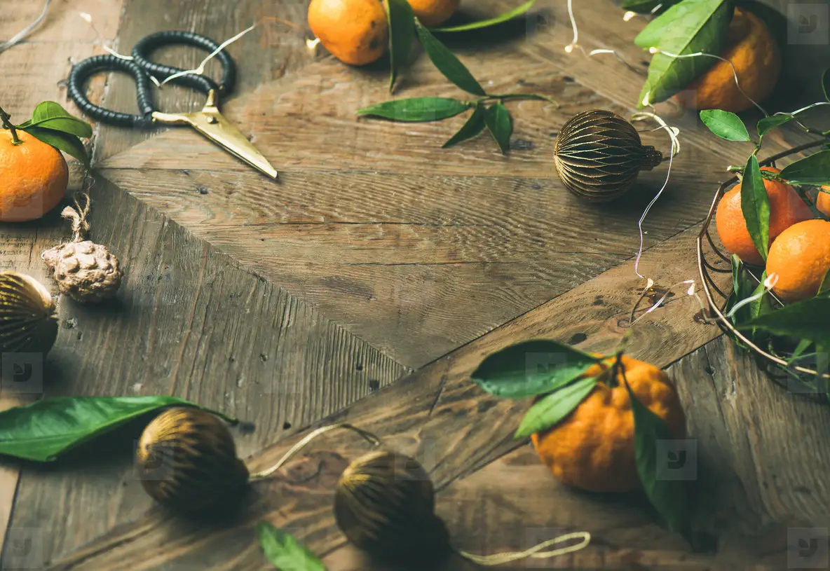 Fresh tangerines  decoration toys over rustic background  copy space