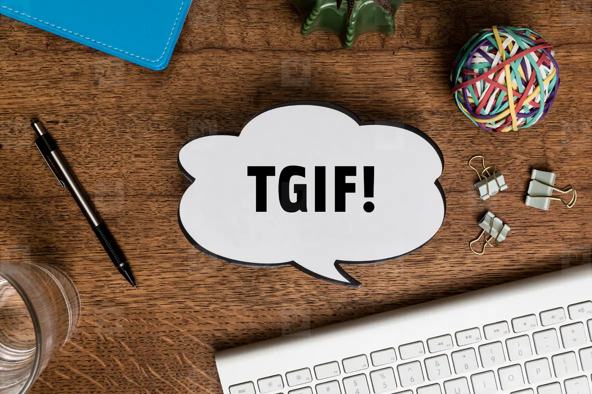 View from above paper TGIF speech bubble on wooden desk  01