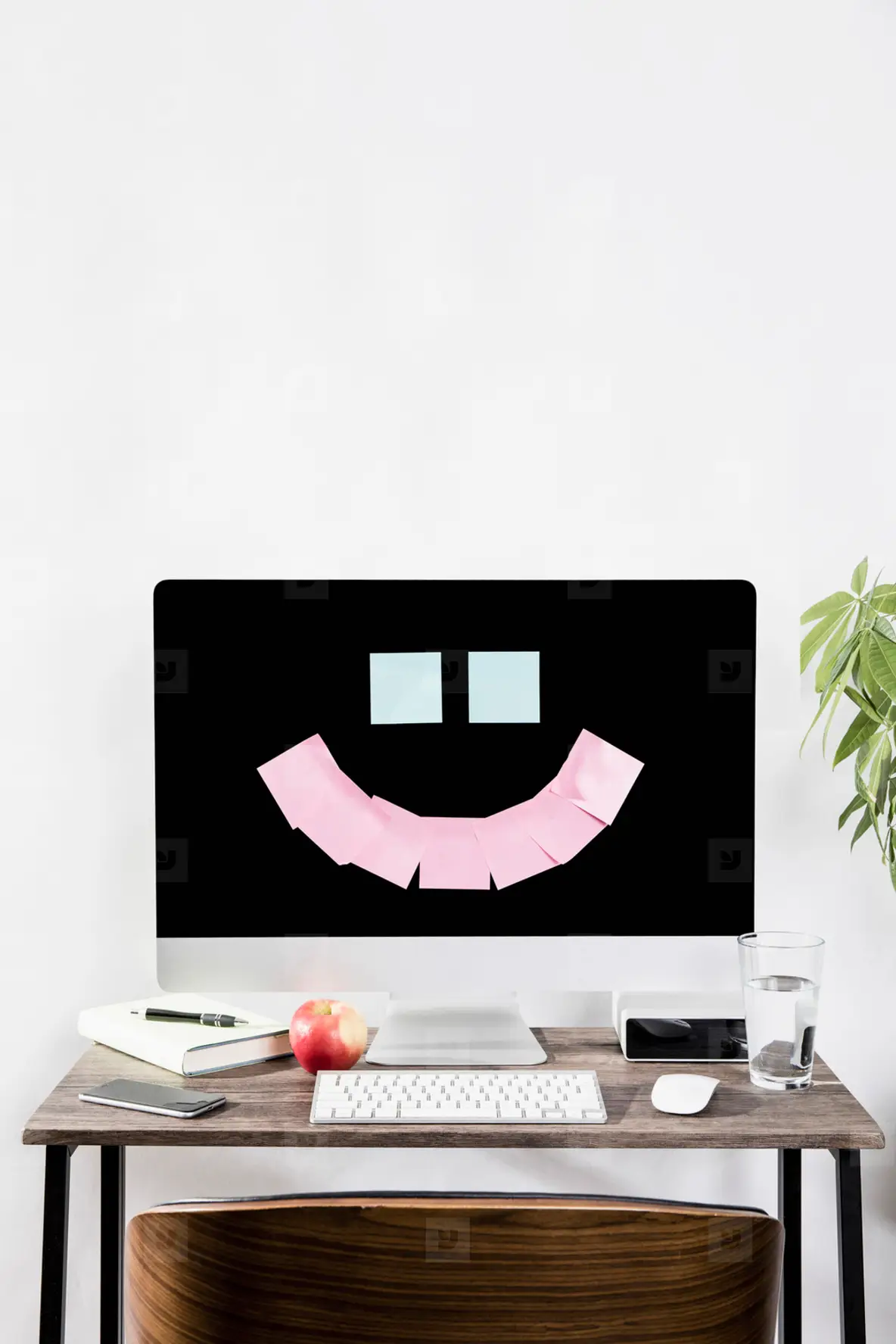 Adhesive notes forming smiley face on computer in office  01