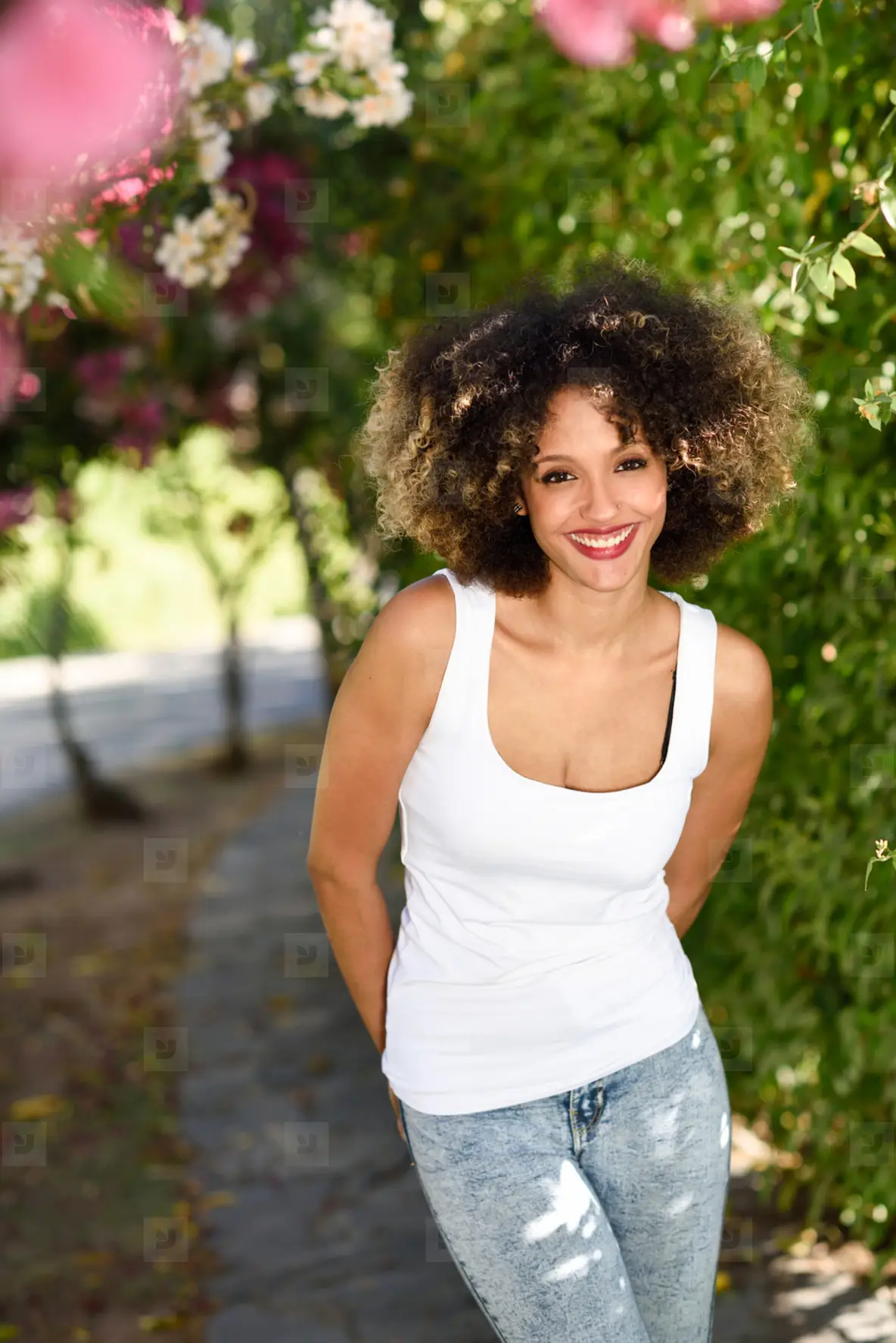Young Black Woman With Afro Hairstyle Smiling In Urban Park Photo ...
