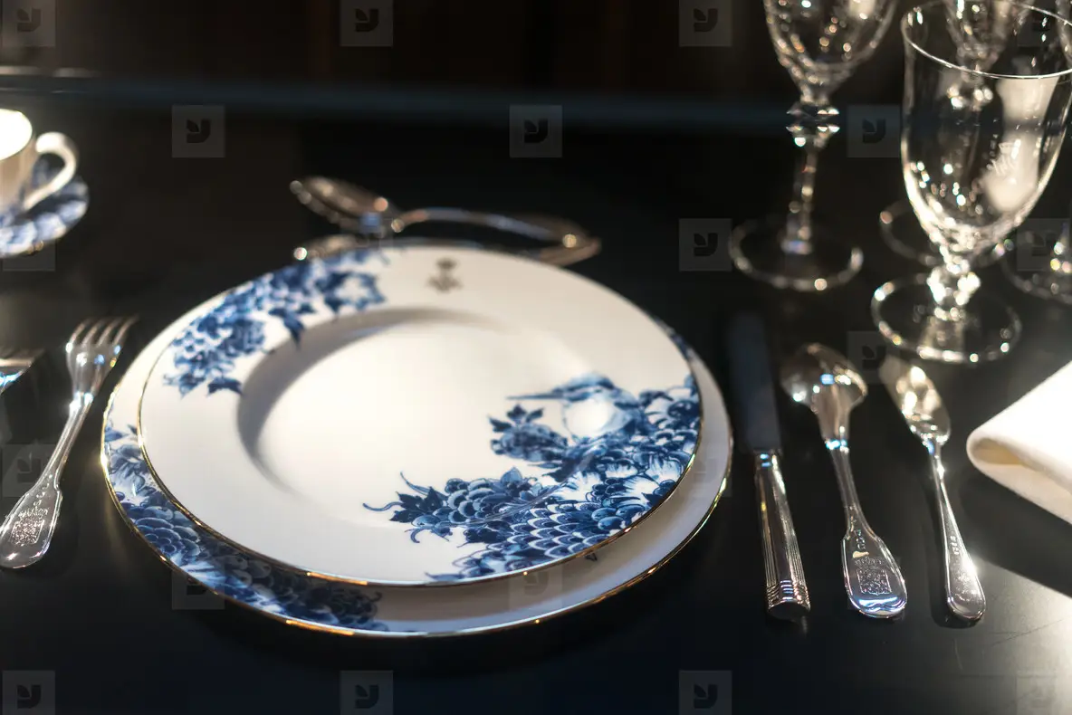Glasses  forks  knives  napkins on dark black table