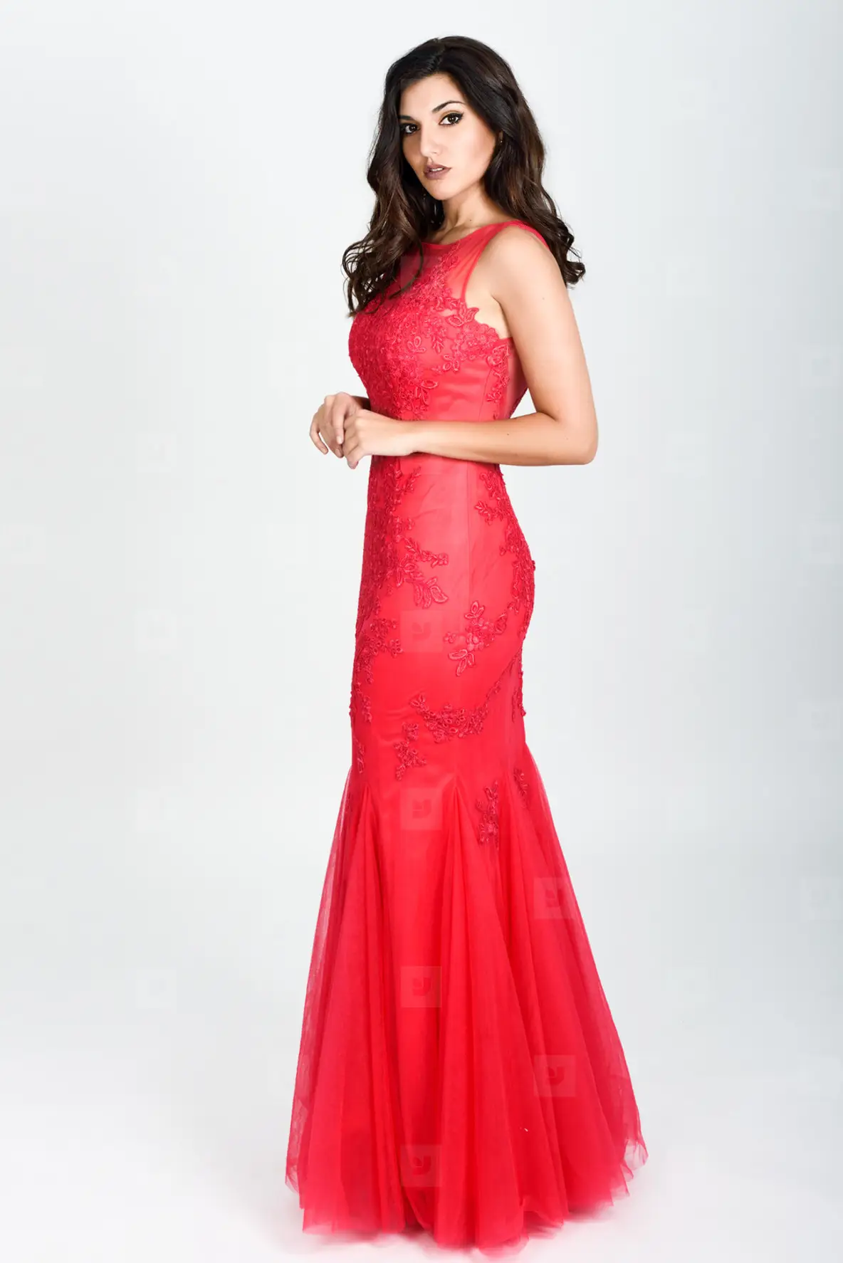 Young woman wearing long red dress on White background Photo Young woman wearing long red dress on White background Photo