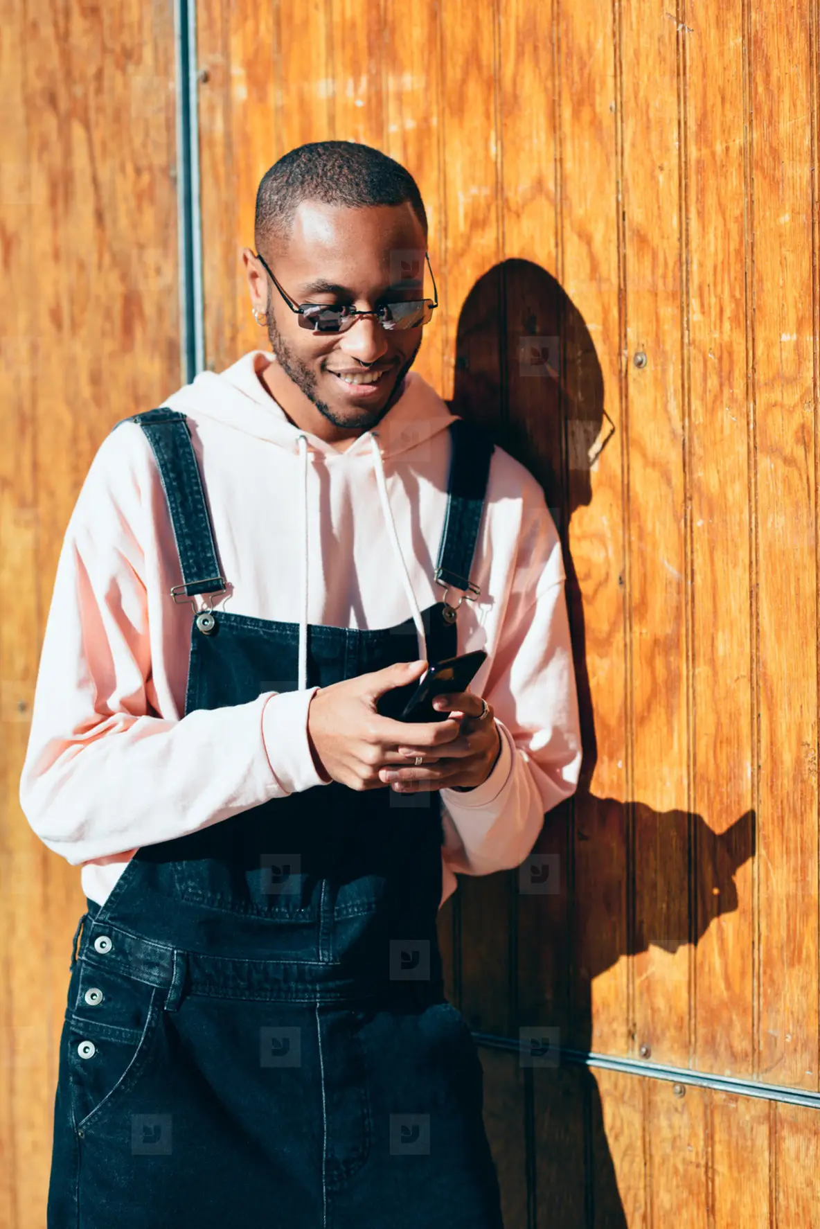 Young Black Man Using Smart Phone Outdoors Photo (184536) - YouWorkForThem