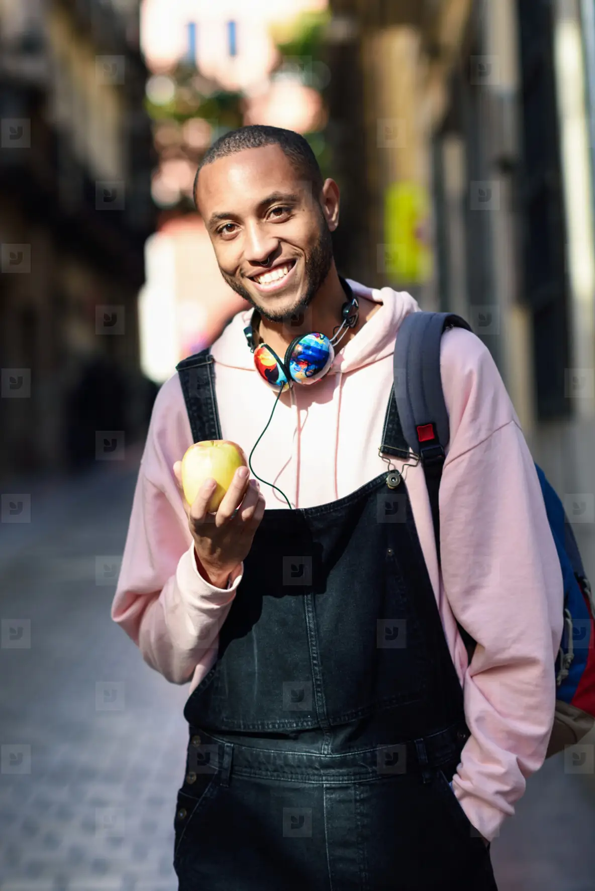 Young Black Man Eating An Apple Walking Down The Street Photo (184551 ...