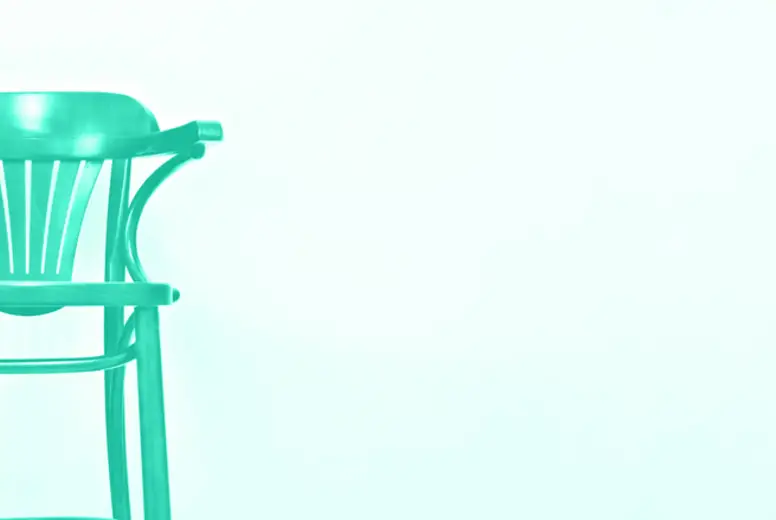 Wooden chair on light wall background with copy space for your text. Trendy green and turquoise color. Style minimalistic concept in mint color. Interior design. Banner