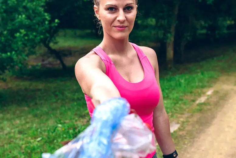 Girl showing garbage she has collected