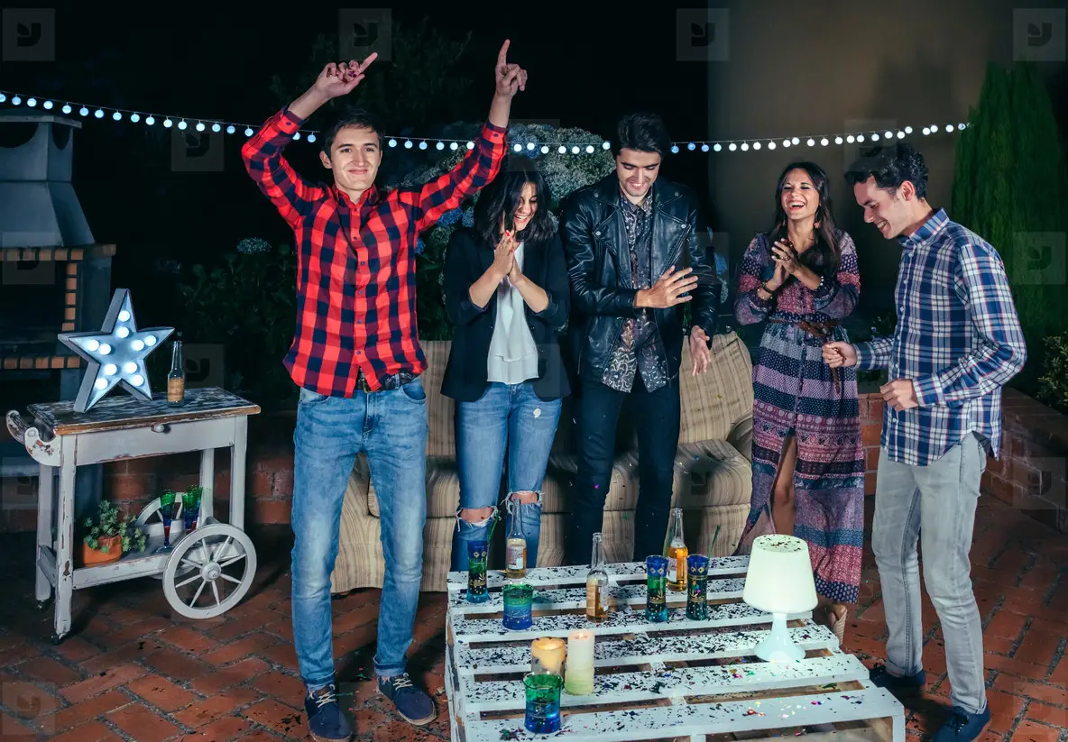 Happy friends dancing and having fun in a party