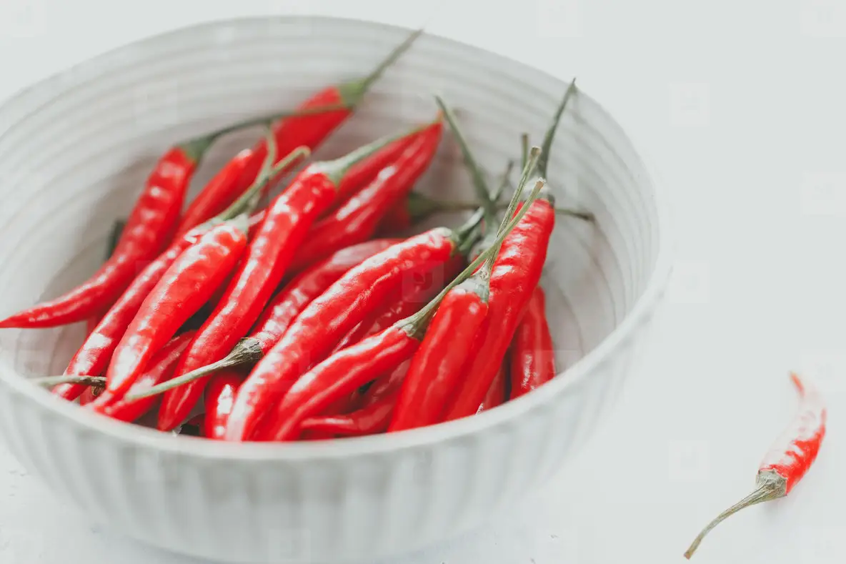 Chili Peppers In A White Ceramic Bowl On A Close Up View