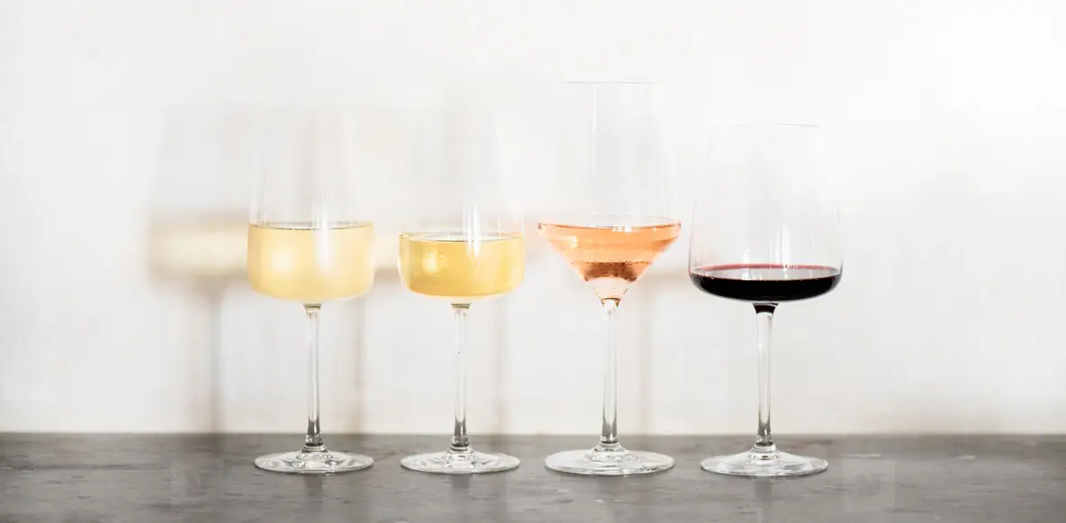 Variety of wine types over concrete table  wide composition