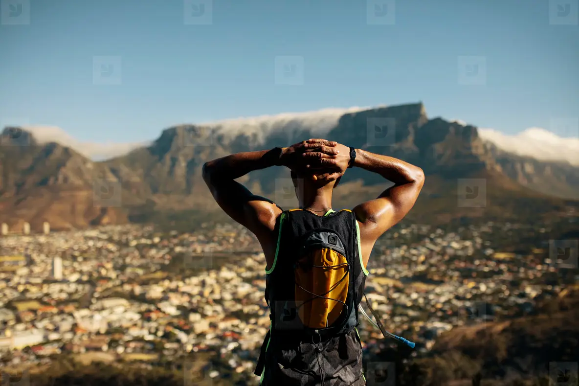 Athletic man taking a break after trail running