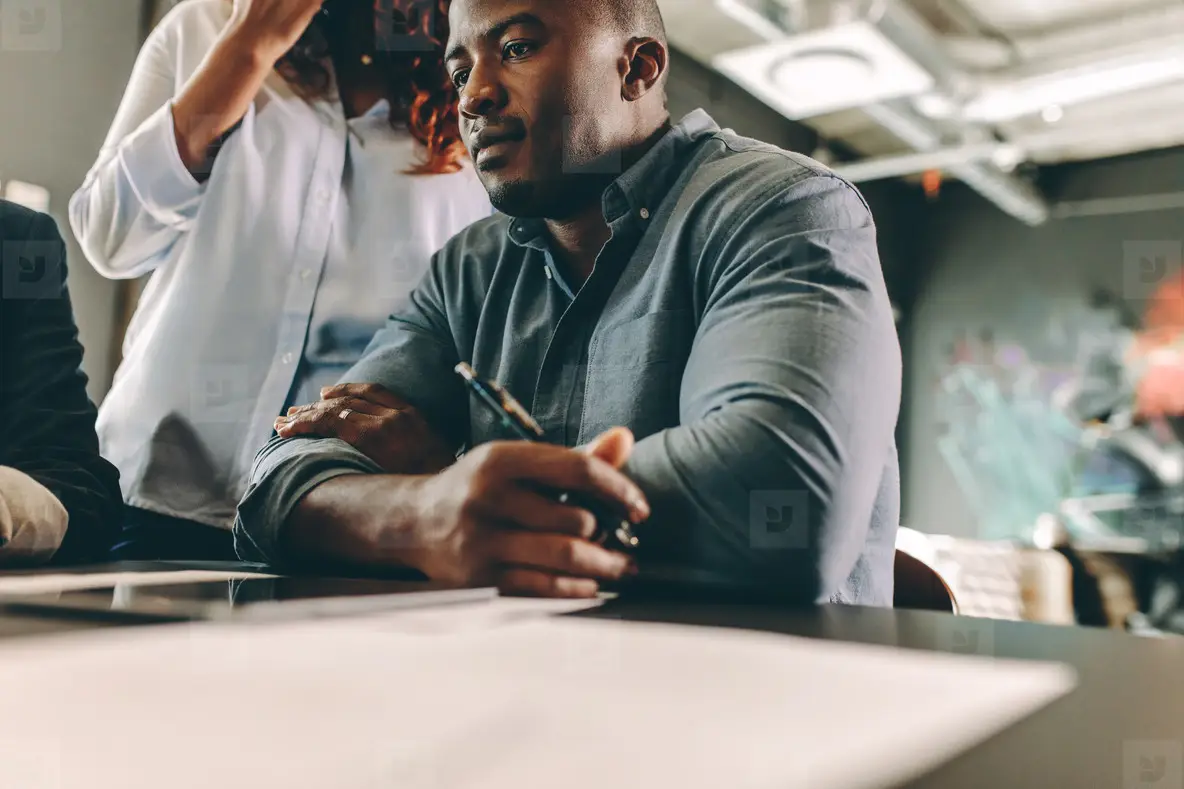 Man in a meeting with colleagues in conference room