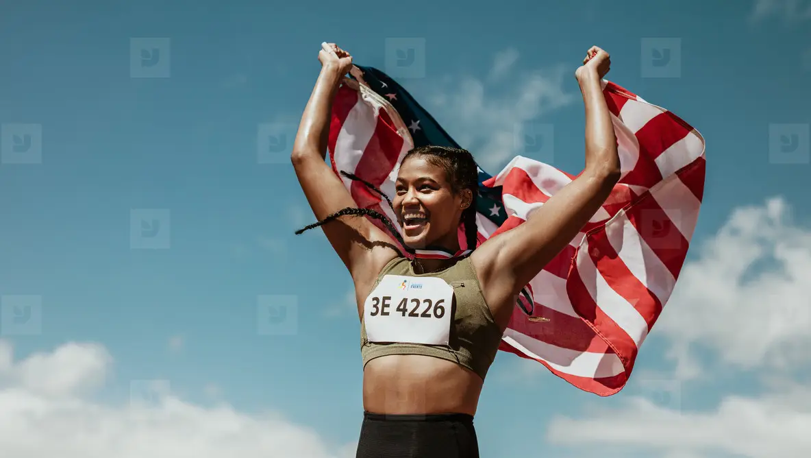 Runner Celebrating Victory Outdoors Holding The US Flag Photo